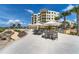Enjoy outdoor dining on the stone patio with tables, chairs, umbrellas and convenient grilling area at 755 Collany Rd # 504, Tierra Verde, FL 33715