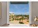 Captivating view from a window overlooking a beautifully landscaped community with palm trees and waterways at 755 Collany Rd # 504, Tierra Verde, FL 33715