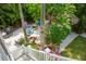 Backyard patio area has lounge chairs around a fire pit and tropical landscaping at 758 Claudia Ln, Palm Harbor, FL 34683