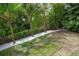 Backyard has a lovely lawn with white rock border and mature trees at 758 Claudia Ln, Palm Harbor, FL 34683