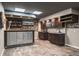 Finished basement bar with a sink, shelving and seating at 758 Claudia Ln, Palm Harbor, FL 34683