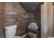 Rustic bathroom features shiplap and metal ceiling with a classic toilet and decorative towels at 758 Claudia Ln, Palm Harbor, FL 34683