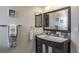 Modern bathroom featuring a stylish sink with a white countertop, a black framed mirror, and a decorative towel rack at 758 Claudia Ln, Palm Harbor, FL 34683