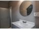 Bathroom featuring a modern sink and vanity, round mirror, and a shower with glass door at 758 Claudia Ln, Palm Harbor, FL 34683