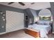 Charming bedroom featuring a decorative ceiling fan, stylish barn door closet, window, and queen bed at 758 Claudia Ln, Palm Harbor, FL 34683