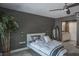 Serene bedroom features natural light, gray walls, a modern ceiling fan, and a decorative houseplant in the corner at 758 Claudia Ln, Palm Harbor, FL 34683