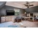 A comfortable bedroom with carpet, ceiling fan, closet, and view of the outside at 758 Claudia Ln, Palm Harbor, FL 34683