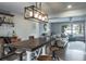 Open dining space with a modern light fixture, seating for four, and views into the living area at 758 Claudia Ln, Palm Harbor, FL 34683