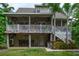 Exterior of home with spacious porch and bar area in the backyard surrounded by mature landscaping at 758 Claudia Ln, Palm Harbor, FL 34683
