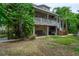 Backyard view of a home with a large porch and bar area beneath the elevated structure at 758 Claudia Ln, Palm Harbor, FL 34683