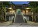 Charming two-story home with a welcoming blue door and dual garages beneath the living space at 758 Claudia Ln, Palm Harbor, FL 34683