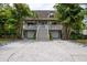 Charming two-story home with a spacious porch, two-car garage, and lush, tropical landscaping at 758 Claudia Ln, Palm Harbor, FL 34683