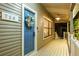 A charming blue front door adorned with a wreath leads to a cozy, covered porch at 758 Claudia Ln, Palm Harbor, FL 34683