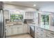 Beautiful kitchen offering stainless steel appliances, modern countertops, and a view to the screened-in porch at 758 Claudia Ln, Palm Harbor, FL 34683