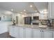 Updated kitchen featuring white cabinets, stainless steel appliances, and sleek countertops, perfect for cooking and entertaining at 758 Claudia Ln, Palm Harbor, FL 34683