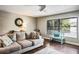 Cozy living room featuring hardwood floors, a comfortable gray sofa, and plenty of natural light at 758 Claudia Ln, Palm Harbor, FL 34683
