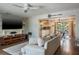 Open-concept living room with hardwood floors, a comfortable sofa, and access to the kitchen at 758 Claudia Ln, Palm Harbor, FL 34683