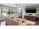 Cozy living room with a plush sofa, hardwood floors, and plenty of natural light at 758 Claudia Ln, Palm Harbor, FL 34683