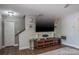 Well-lit living room featuring a large entertainment center and staircase in a modern style at 758 Claudia Ln, Palm Harbor, FL 34683