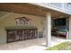 Outdoor entertaining area with a bar, television, and covered ceiling near the Ozona Barkhouse at 758 Claudia Ln, Palm Harbor, FL 34683