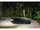 Beautiful backyard pool surrounded by lush tropical foliage, offering a serene oasis at 758 Claudia Ln, Palm Harbor, FL 34683
