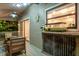 Inviting covered porch with bar and seating area overlooking lush backyard landscaping at 758 Claudia Ln, Palm Harbor, FL 34683