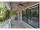 Relaxing porch with comfortable seating, ceiling fans, and an entry door at 758 Claudia Ln, Palm Harbor, FL 34683
