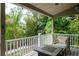 Covered porch with comfortable seating and views of lush landscaping at 758 Claudia Ln, Palm Harbor, FL 34683
