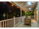 Charming covered porch with string lights, ceiling fans, and comfortable seating, perfect for outdoor enjoyment at 758 Claudia Ln, Palm Harbor, FL 34683