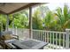 Covered porch with comfortable seating and views of lush landscaping at 758 Claudia Ln, Palm Harbor, FL 34683