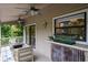 Relaxing covered porch with ceiling fans and comfortable seating at 758 Claudia Ln, Palm Harbor, FL 34683