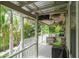 Large covered porch with outdoor seating and views of lush landscaping at 758 Claudia Ln, Palm Harbor, FL 34683