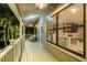 Enjoy the outdoors on this spacious porch, featuring ceiling fans and comfortable furniture at 758 Claudia Ln, Palm Harbor, FL 34683