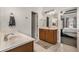 Bright bathroom featuring double sinks, a neutral color palette, and a glimpse into the connected bedroom at 7606 S Sparkman St, Tampa, FL 33616