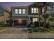 Two-story home with a two-car garage, beautifully landscaped yard, and charming front porch at 7606 S Sparkman St, Tampa, FL 33616