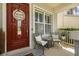Inviting front porch with seating area, decorative welcome sign, and well-maintained landscaping at 7606 S Sparkman St, Tampa, FL 33616
