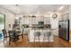 Well-lit kitchen with gray cabinets, stainless steel appliances, and granite countertops at 7606 S Sparkman St, Tampa, FL 33616