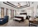 Spacious main bedroom with decorative tray ceiling, dark wood furniture, and soft natural light at 7606 S Sparkman St, Tampa, FL 33616