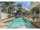 A screened-in pool and spa with stone surround, providing a private outdoor oasis at 7606 S Sparkman St, Tampa, FL 33616