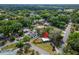 Aerial view of a cozy home with a spacious fenced yard and mature trees in a neighborhood at 901 King St, Plant City, FL 33563