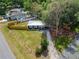 Aerial view of a cozy home with a spacious yard and mature trees in a friendly neighborhood at 901 King St, Plant City, FL 33563