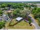 Aerial view of a cozy home with a spacious yard and mature trees near the highway at 901 King St, Plant City, FL 33563