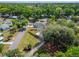 Aerial view of a cozy home with a spacious fenced yard and mature trees in a neighborhood at 901 King St, Plant City, FL 33563