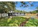 This backyard features a well-maintained lawn, a play area, and space for outdoor enjoyment at 901 King St, Plant City, FL 33563