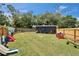 Large backyard with a well-maintained lawn, ideal for Gathering activities and outdoor entertaining at 901 King St, Plant City, FL 33563