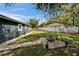 Backyard with a fire pit area, swing and plenty of green space, perfect for outdoor entertaining and relaxation at 901 King St, Plant City, FL 33563