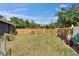 The backyard has a spacious lawn, secure fence, and is perfect for relaxing or playing outdoor games at 901 King St, Plant City, FL 33563