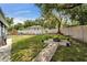 Spacious backyard featuring green grass, fire pit, and swing at 901 King St, Plant City, FL 33563