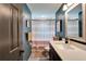 Bathroom featuring blue wall, modern vanity, and shower with striped curtain at 901 King St, Plant City, FL 33563