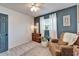 Well-lit bedroom featuring trendy colors, a decorative rug and an armchair at 901 King St, Plant City, FL 33563